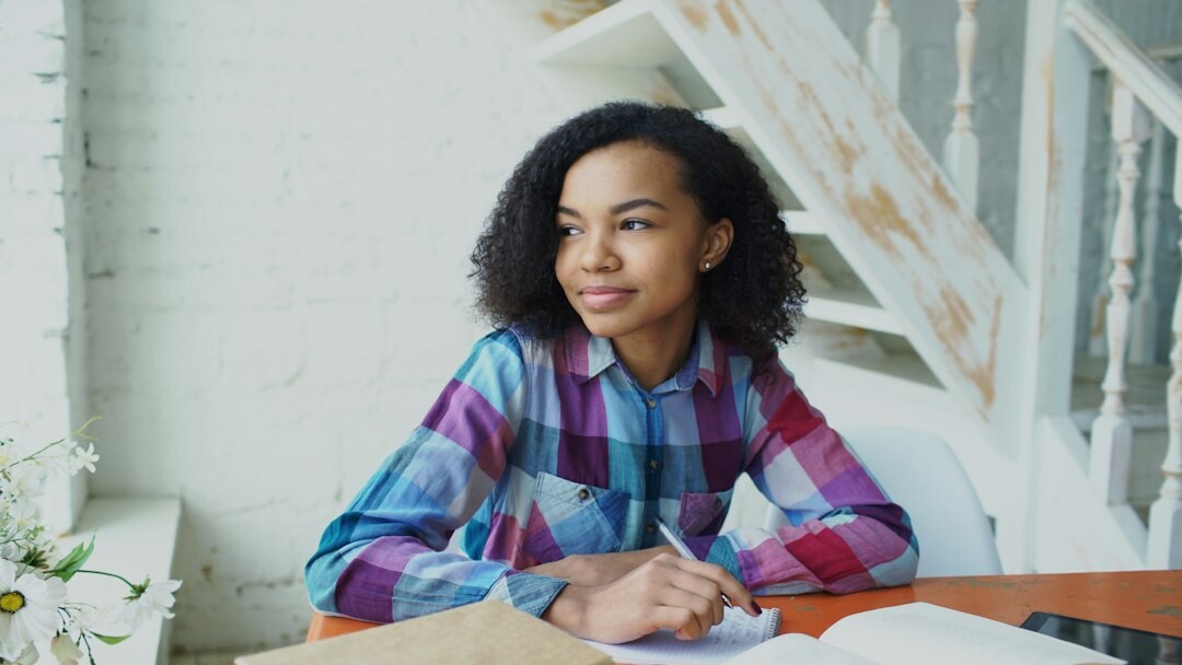 young writer at desk with notebook
