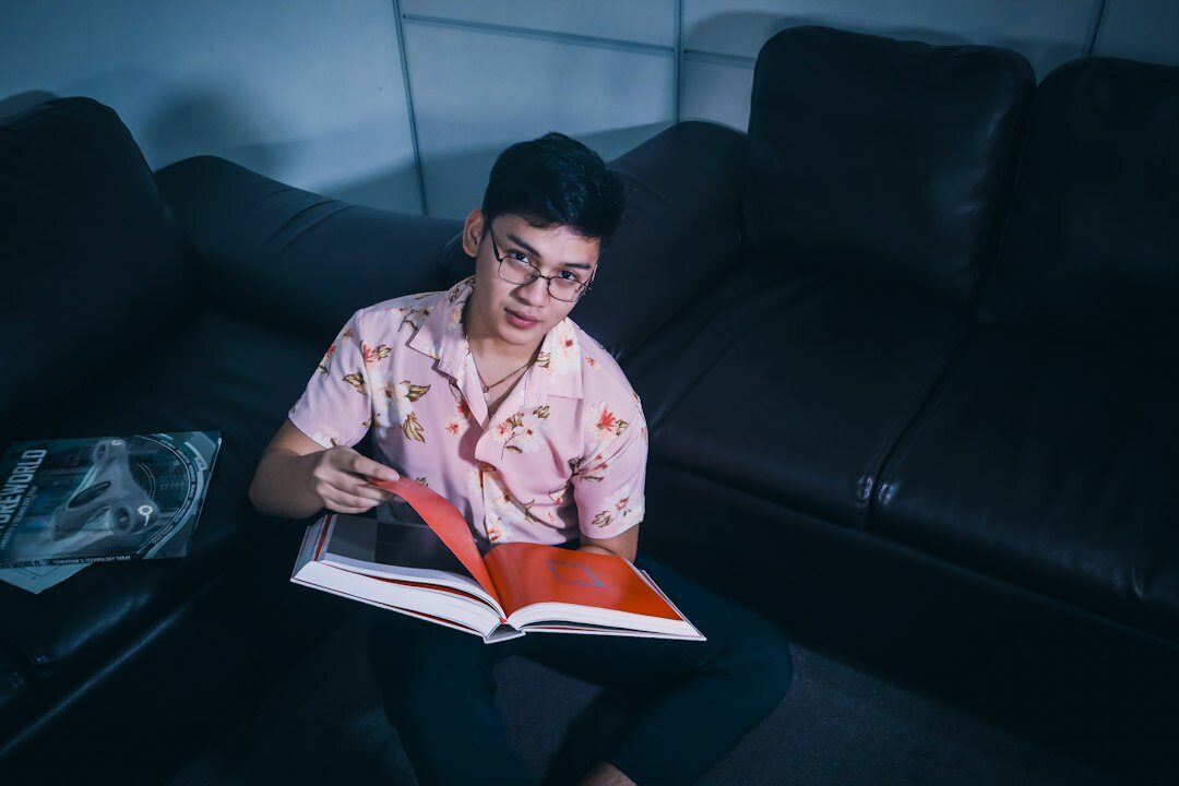 person reading thriller book at night